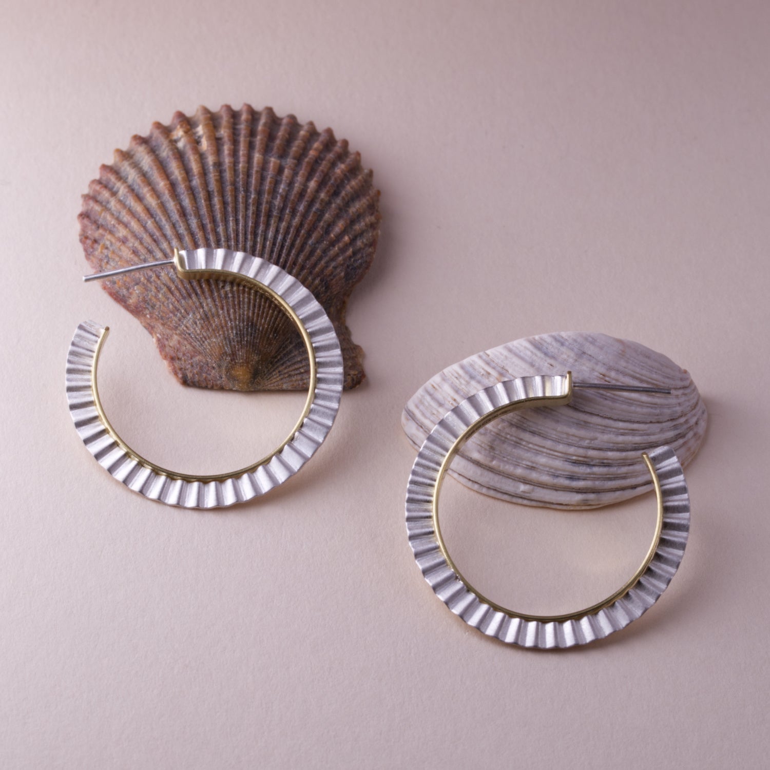 gold and silver sculpted contemporary hoop earrings by Clara Breen